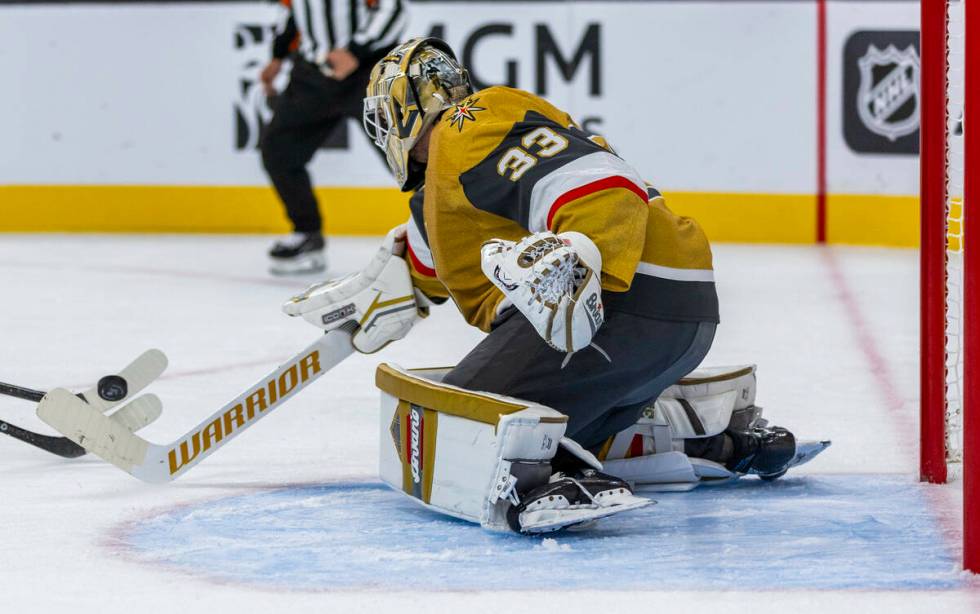 Golden Knights goaltender Adin Hill (33) deflects a shot by the Utah Hockey Club during the thi ...