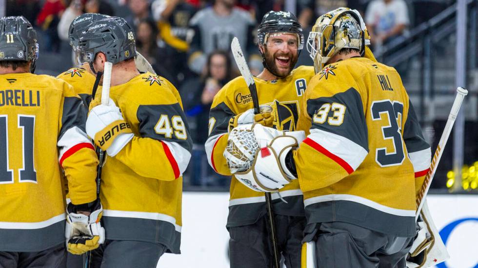 Golden Knights defenseman Alex Pietrangelo (7) congratulates goaltender Adin Hill (33) on their ...