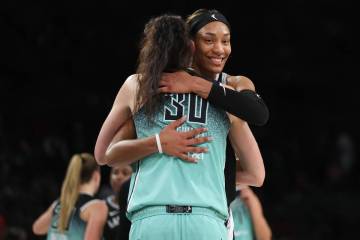 Las Vegas Aces center A'ja Wilson (22) hugs New York Liberty forward Breanna Stewart (30) after ...