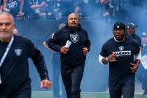 Raiders Head Coach Antonio Pierce and others take the field before the first half of the Raider ...