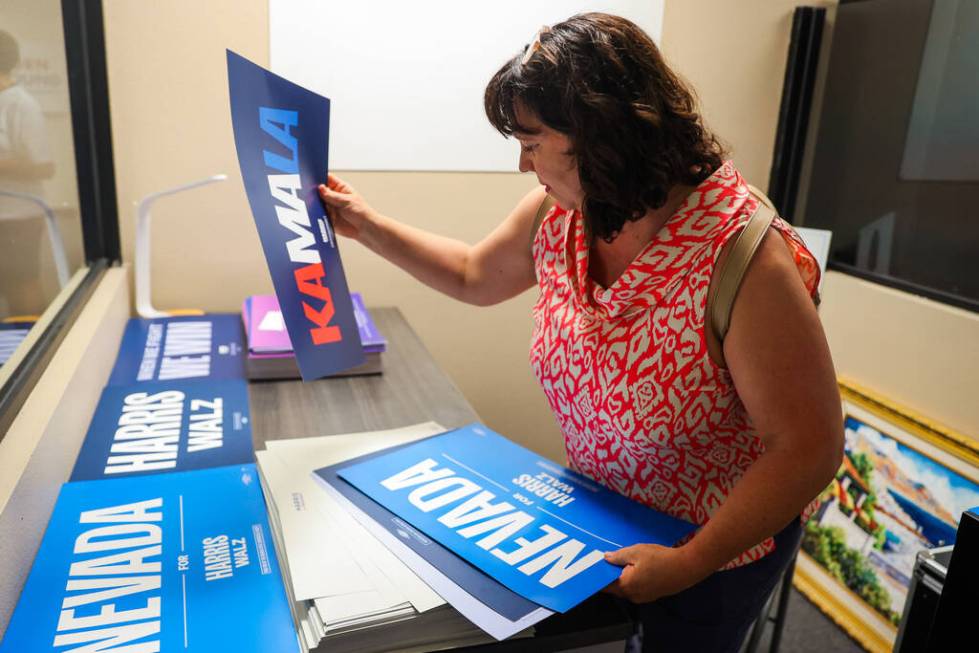 FILE - Jeana Blackman Taylor sorts through Kamala Harris signs during a delegate sendoff ahead ...