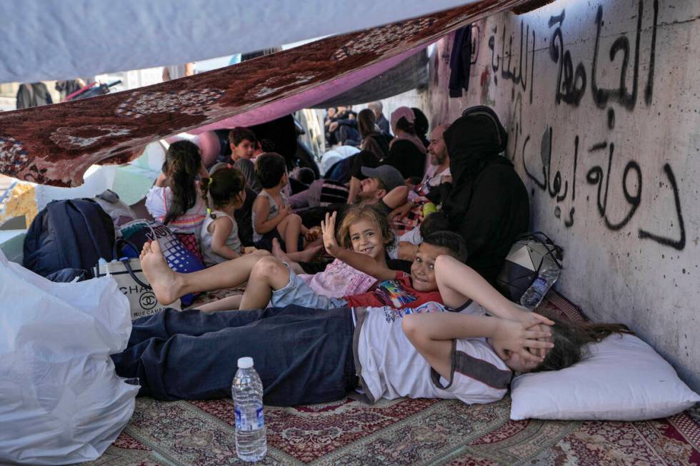 Children with their families lie on the ground in Beirut's Martyrs' square after fleeing the Is ...