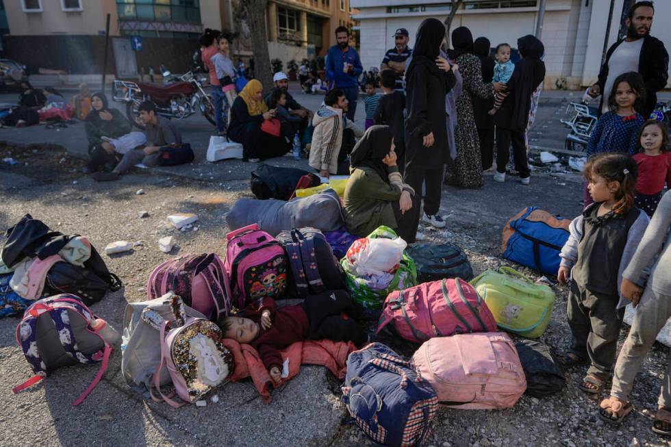 Families gather in Martyrs' square after fleeing the Israeli airstrikes in Beirut's southern su ...