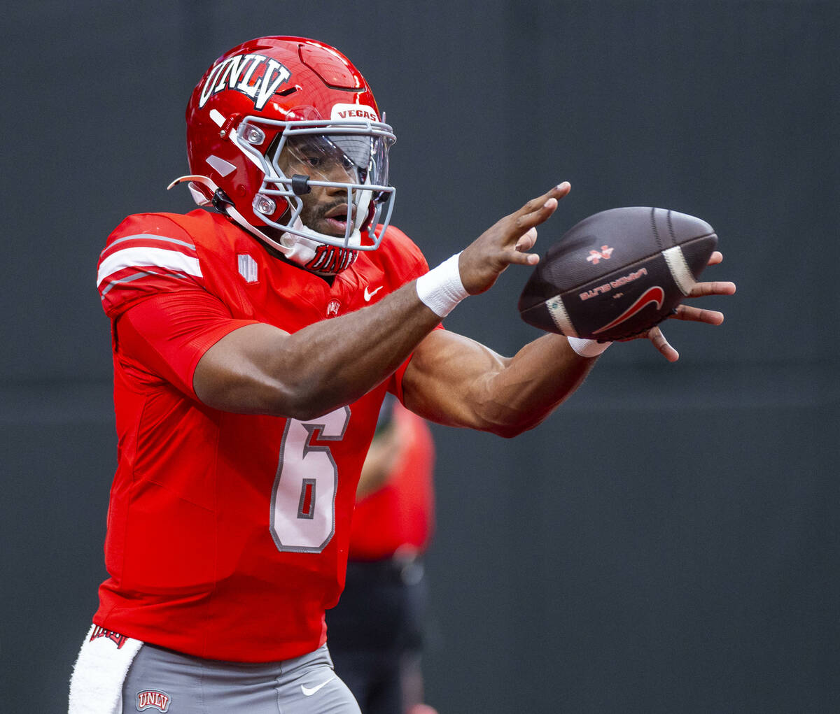 UNLV quarterback Hajj-Malik Williams (6) takes a snap during warm ups of their NCAA football ga ...