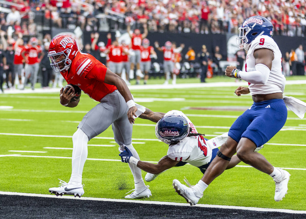 UNLV quarterback Hajj-Malik Williams (6) scores his first touchdown over Fresno State Bulldogs ...