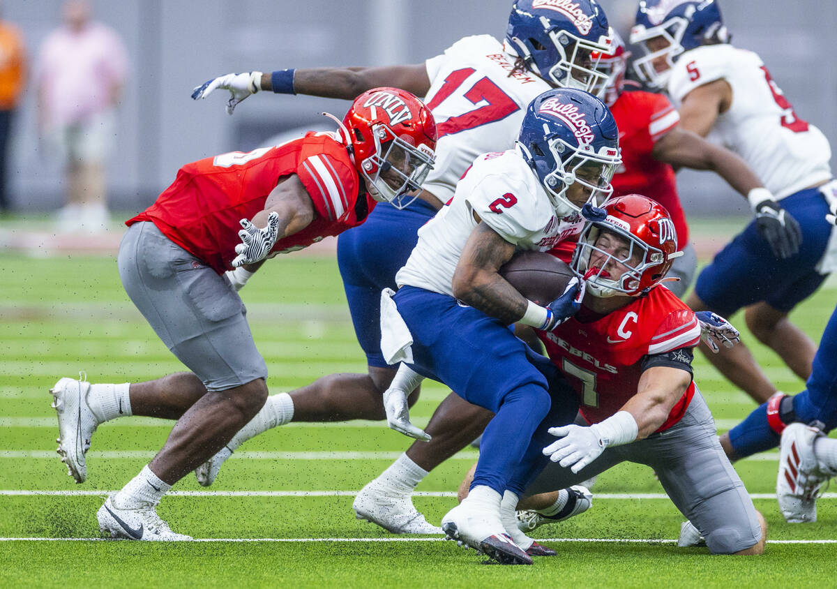 Fresno State running back Malik Sherrod (2) is stopped for a loss by UNLV linebacker Jackson Wo ...