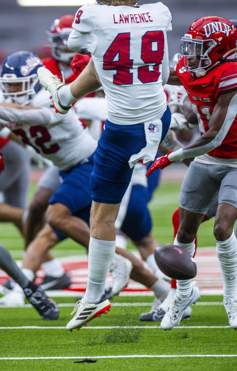 Fresno State punter Clay Lawrence (49) has a punt blocked by UNLV defensive back Rashod Tanner ...