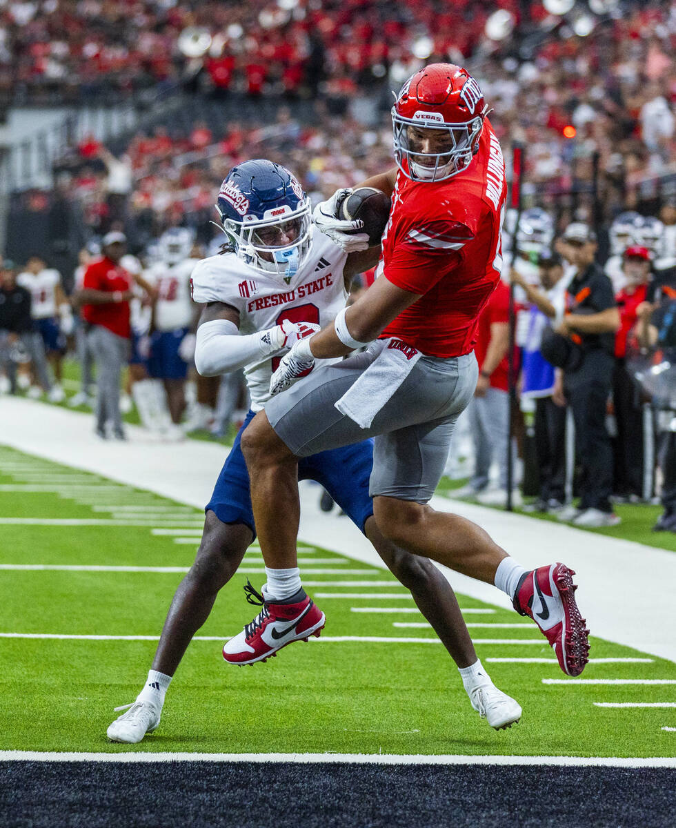 UNLV tight end Kaleo Ballungay (19) comes down with a touchdown reception over Fresno State Bul ...