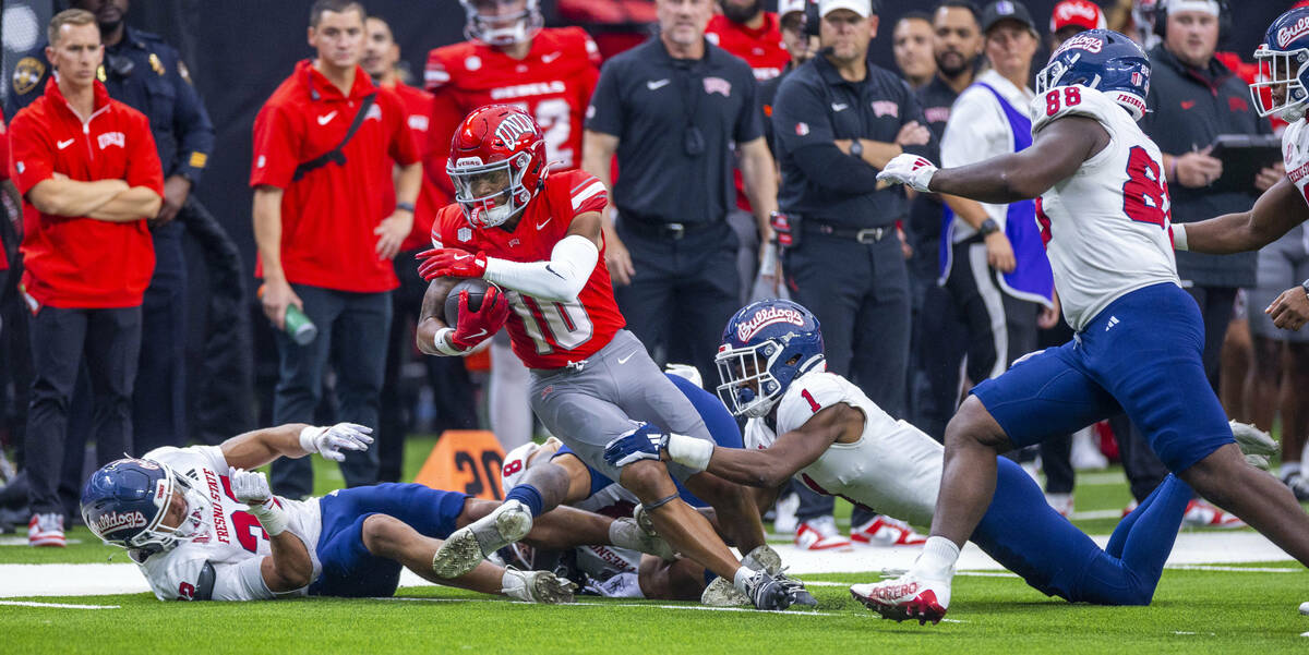 UNLV wide receiver DeAngelo Irvin Jr. (10) looks to break free from Fresno State defensive back ...