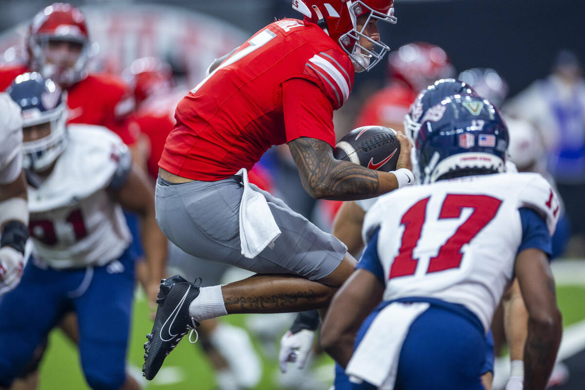 UNLV quarterback Cameron Friel (7) leaps into the end zone for a late score as Fresno State Bul ...