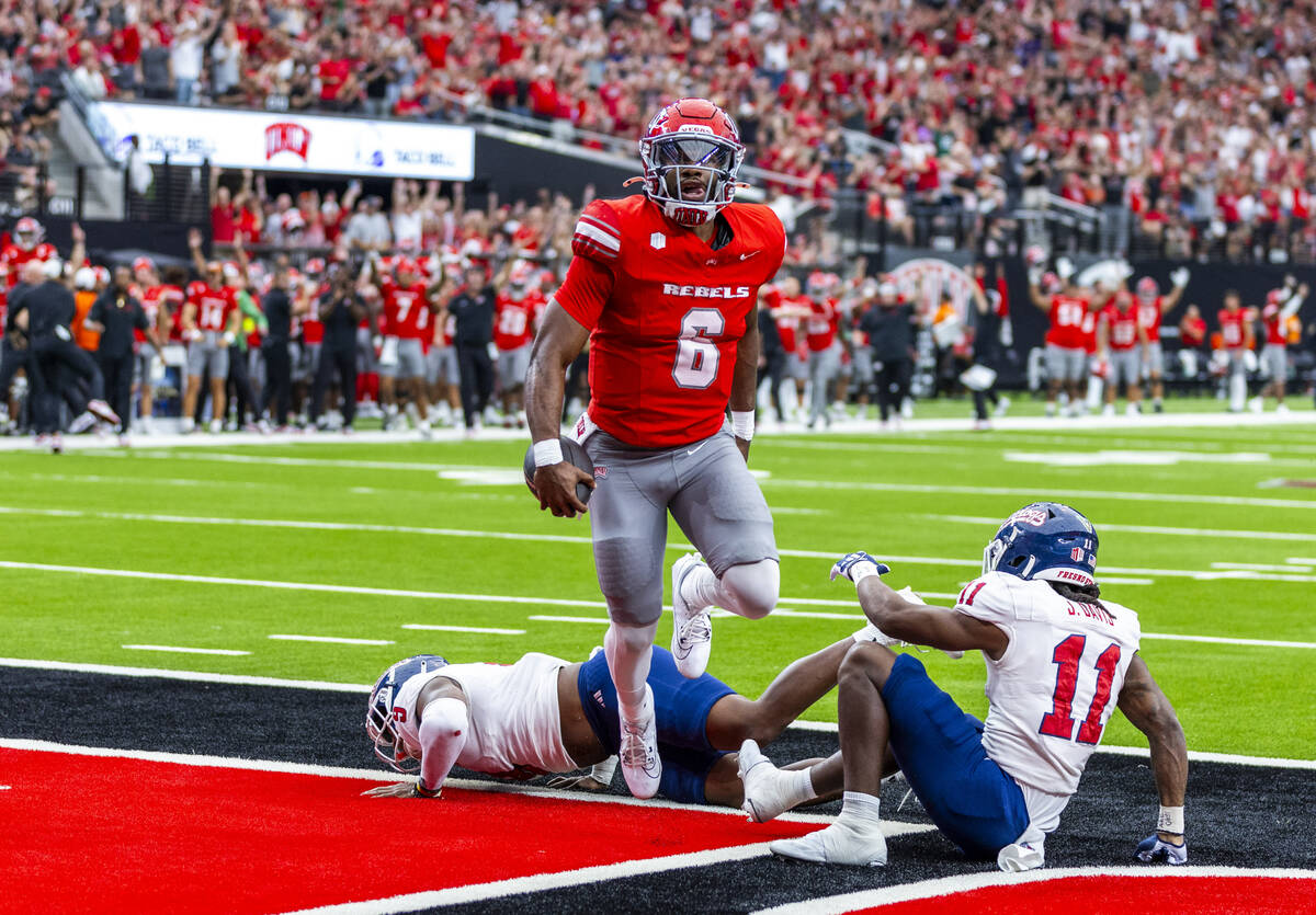 UNLV quarterback Hajj-Malik Williams (6) jumps over Fresno State Bulldogs linebacker Malachi La ...