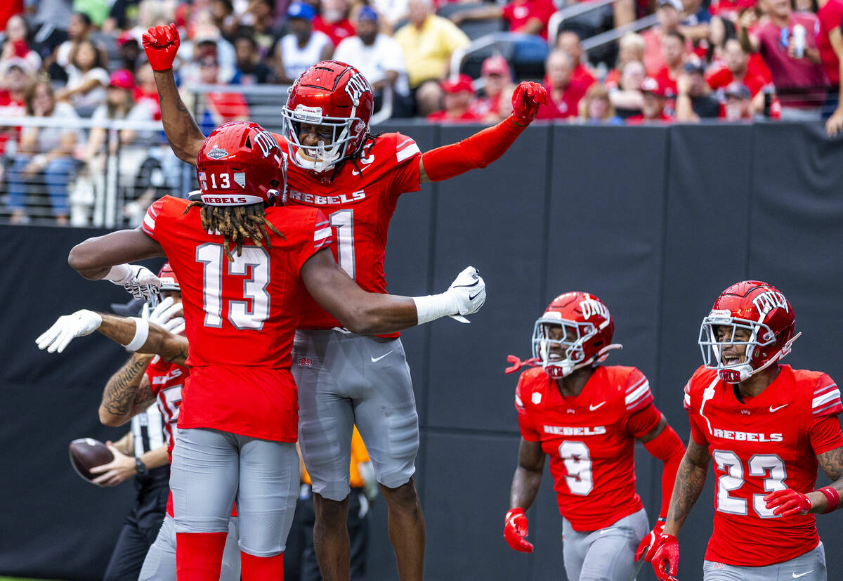 UNLV wide receiver Corey Thompson Jr. (13) celebrates a touchdown by wide receiver Ricky White ...