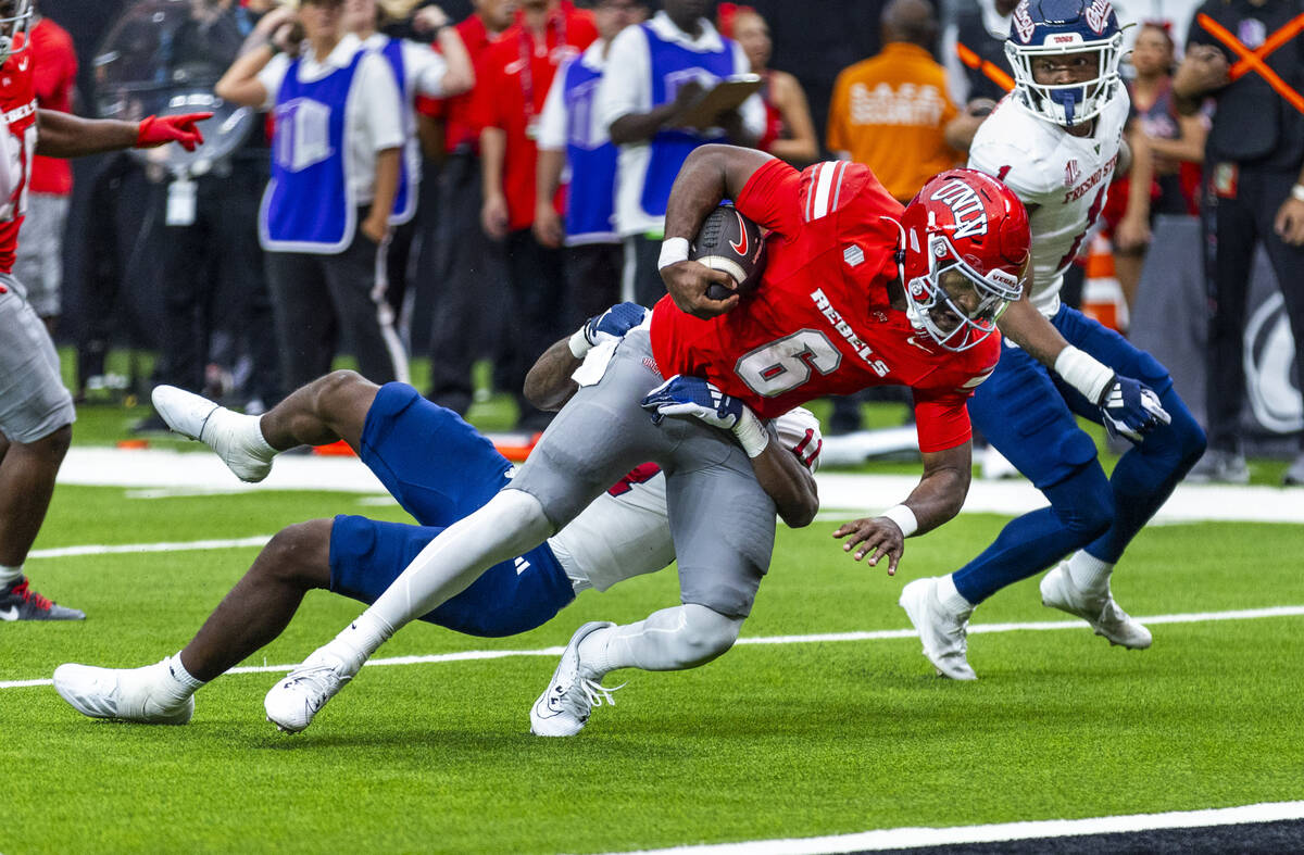 UNLV quarterback Hajj-Malik Williams (6) looks to the end zone as Fresno State Bulldogs defensi ...