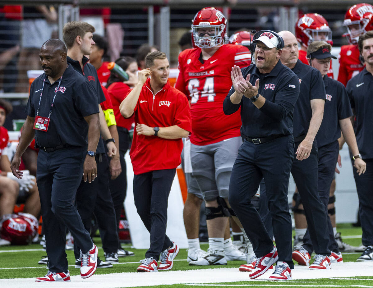 UNLV Head Coach Barry Odom keeps his players motivated after a score against the Fresno State B ...