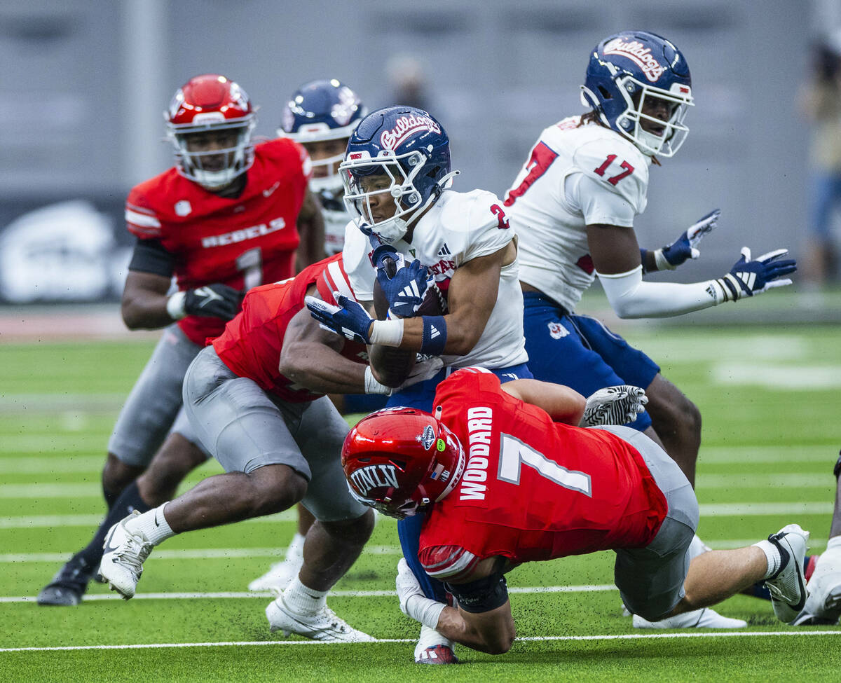 Fresno State Bulldogs running back Malik Sherrod (2) is stopped for a loss by UNLV linebacker J ...