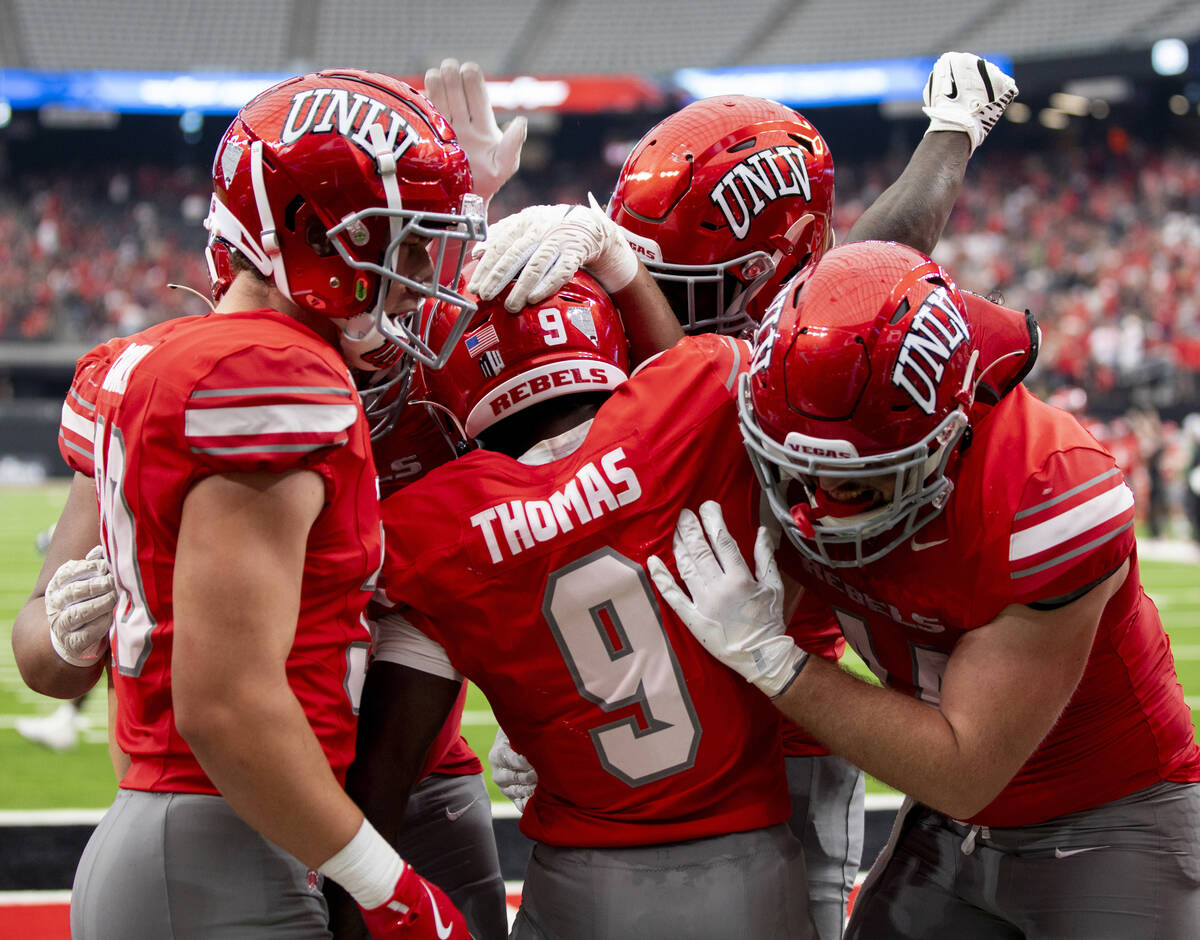 UNLV running back Jai'Den Thomas (9) celebrates with teammates after scoring a touchdown during ...