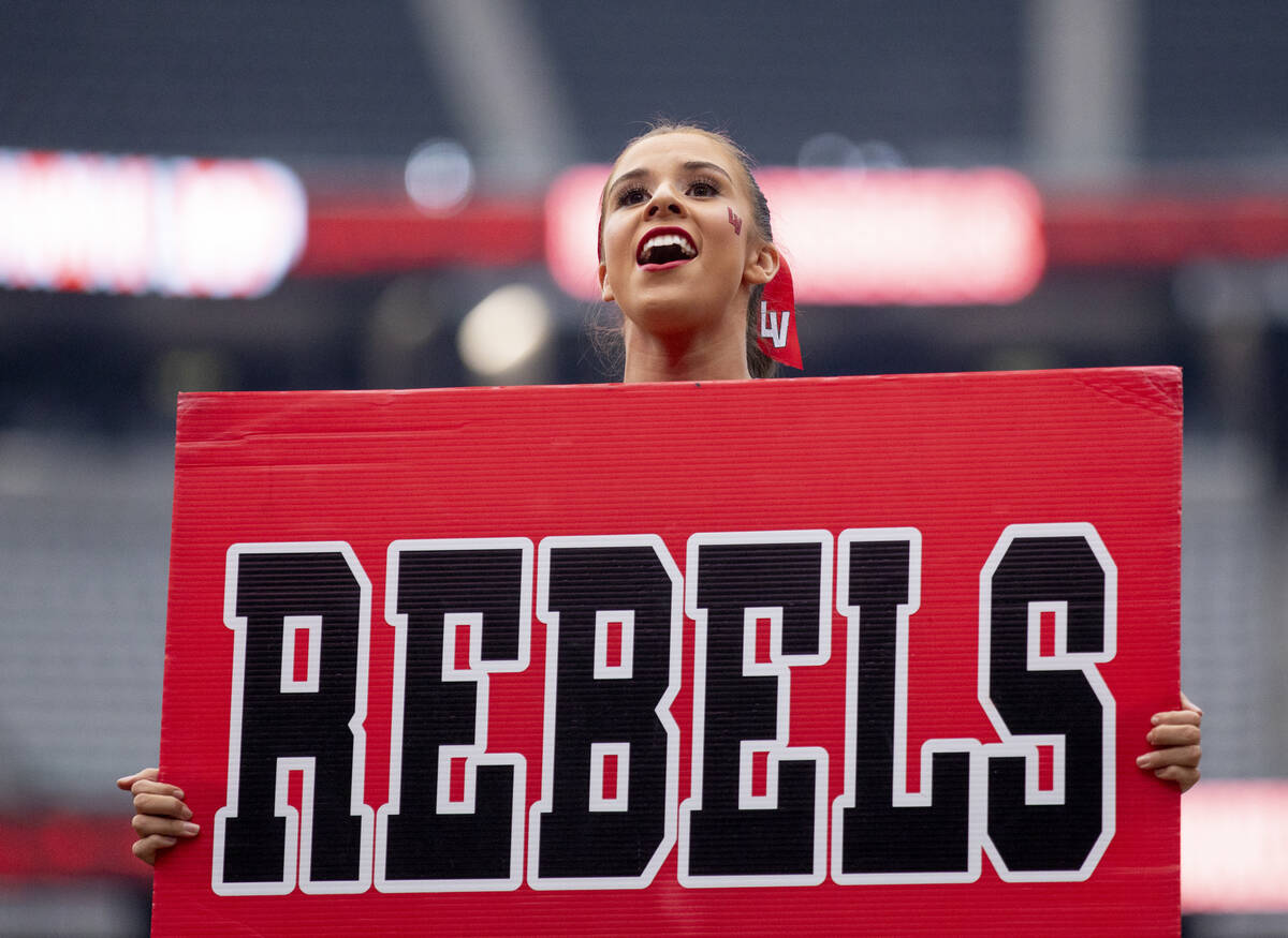 A UNLV cheerleader hypes up the crowd to start the fourth quarter during the college football g ...