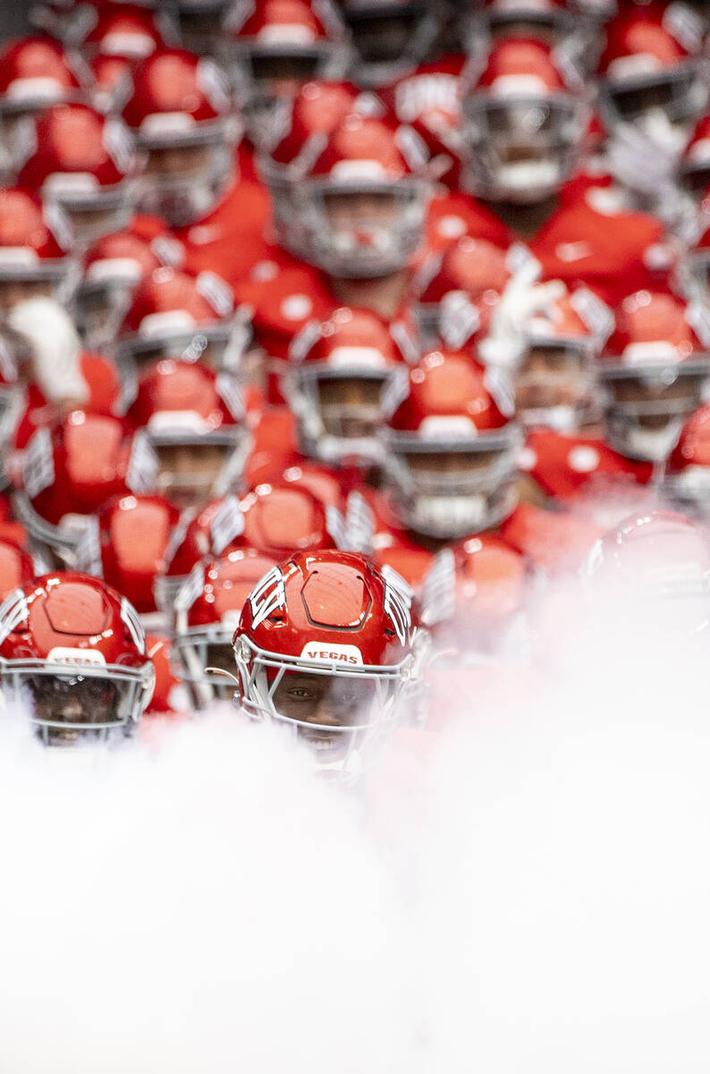 UNLV defensive back Jett Elad (9) runs out of the tunnel before the college football game again ...