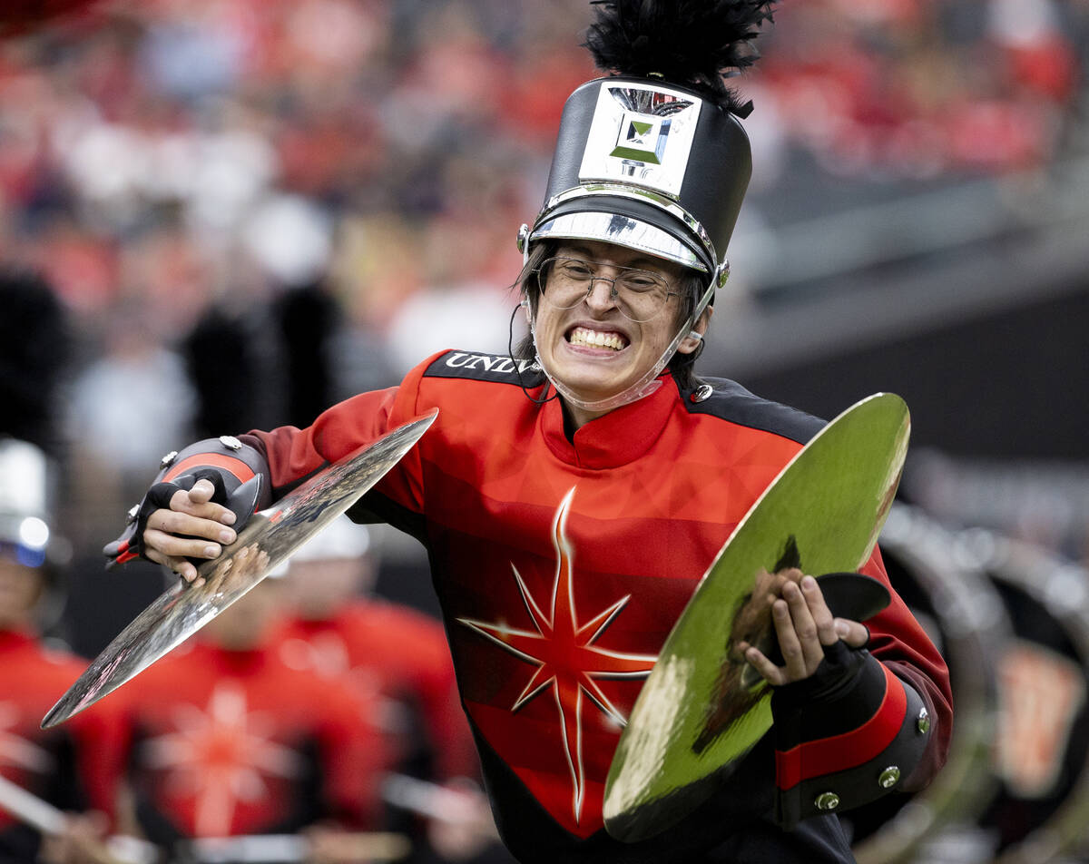 A UNLV Star of Nevada Marching Band cymbal player performs before the college football game aga ...