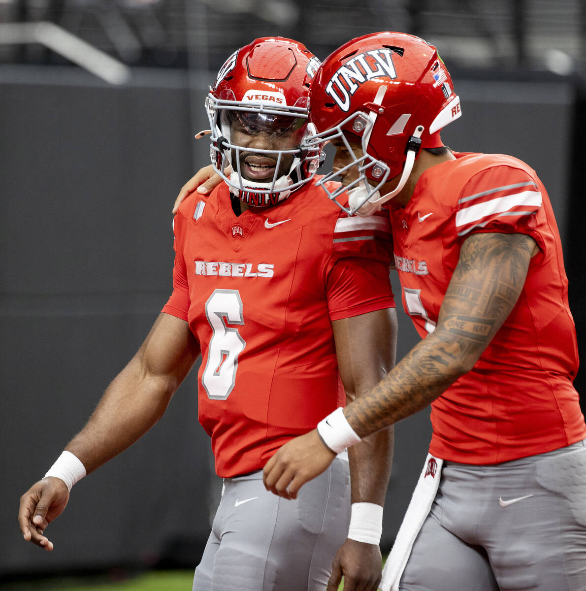 UNLV quarterback Hajj-Malik Williams (6) and quarterback Cameron Friel (7) talk before the coll ...