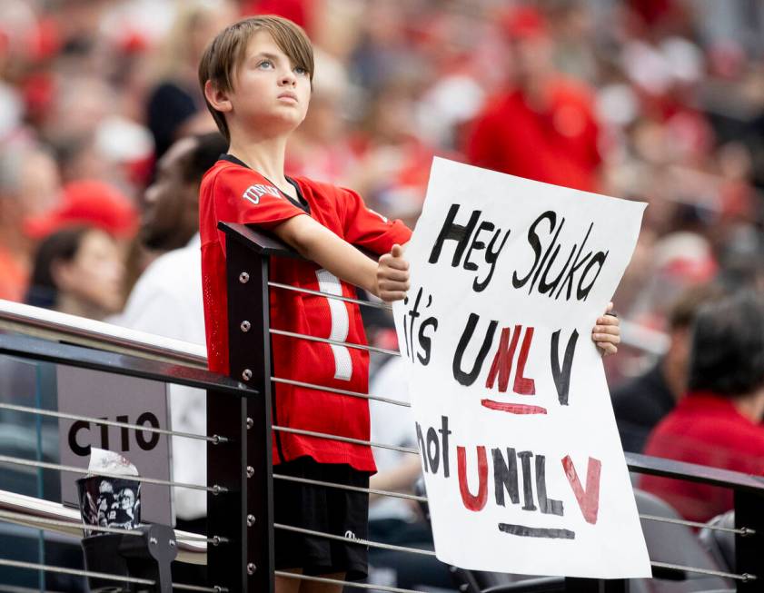 A young UNLV fan holds a sign before the college football game against Fresno State at Allegian ...