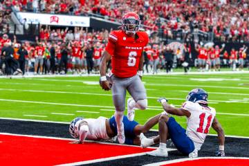 UNLV quarterback Hajj-Malik Williams (6) jumps over Fresno State Bulldogs linebacker Malachi La ...