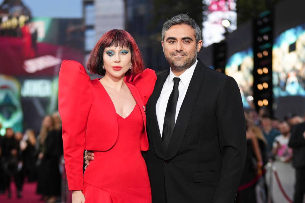 Lady Gaga, left, and Michael Polansky pose for photographers upon arrival at the premiere for t ...