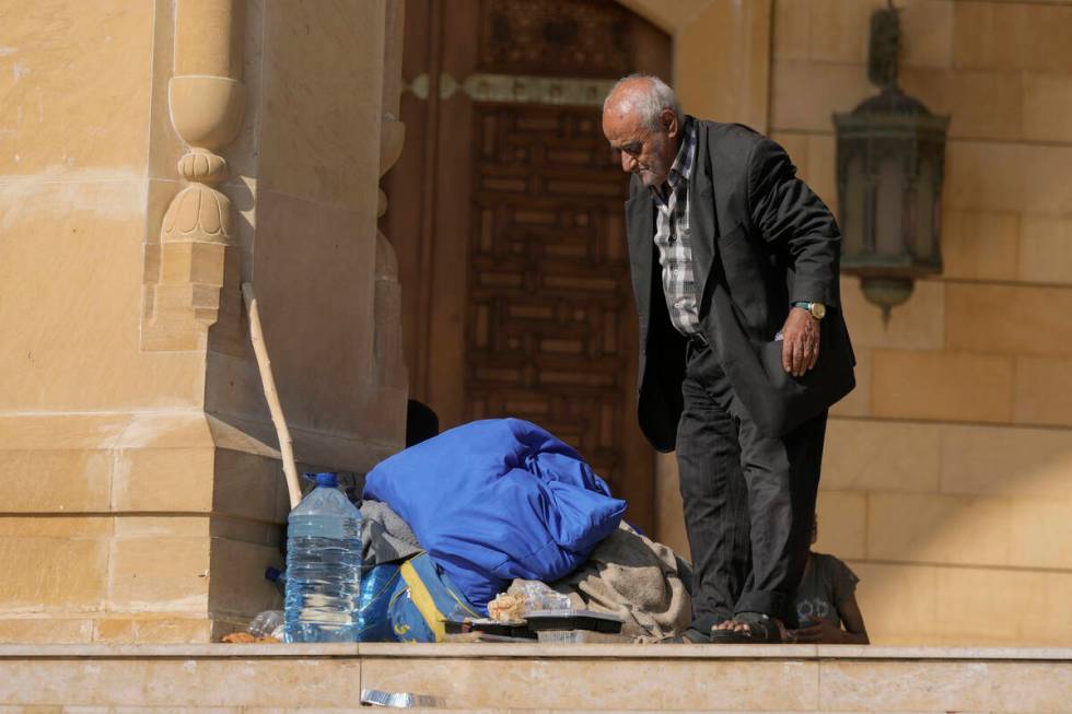 An elderly man stands near al-Amin Mosque in Beirut's Martyrs' square after fleeing the Israeli ...