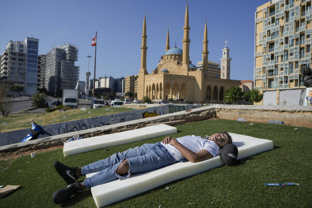 A boy sleeps in Beirut's Martyrs' square after fleeing the Israeli airstrikes in the southern s ...