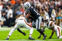 Raiders wide receiver Tre Tucker (11) looks to break a tackle by Cleveland Browns safety Ronnie ...