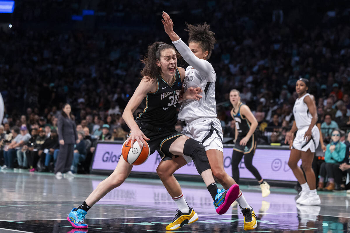 New York Liberty forward Brenna Stewart, left, is defended by Las Vegas Aces forward Alysha Cla ...