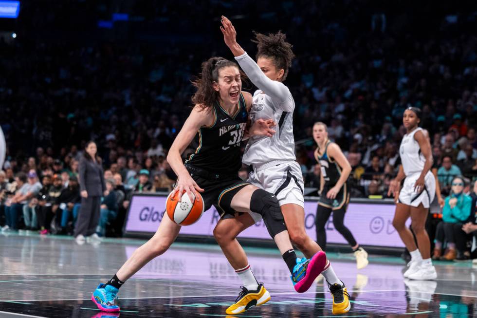 New York Liberty forward Brenna Stewart, left, is defended by Las Vegas Aces forward Alysha Cla ...