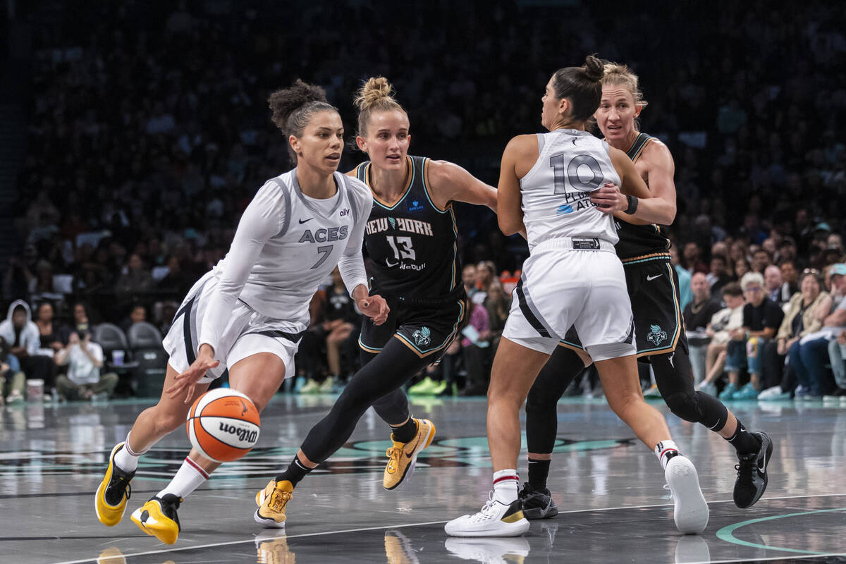 Las Vegas Aces forward Alysha Clark (7) drives past New York Liberty forward Leonie Fiebich (13 ...