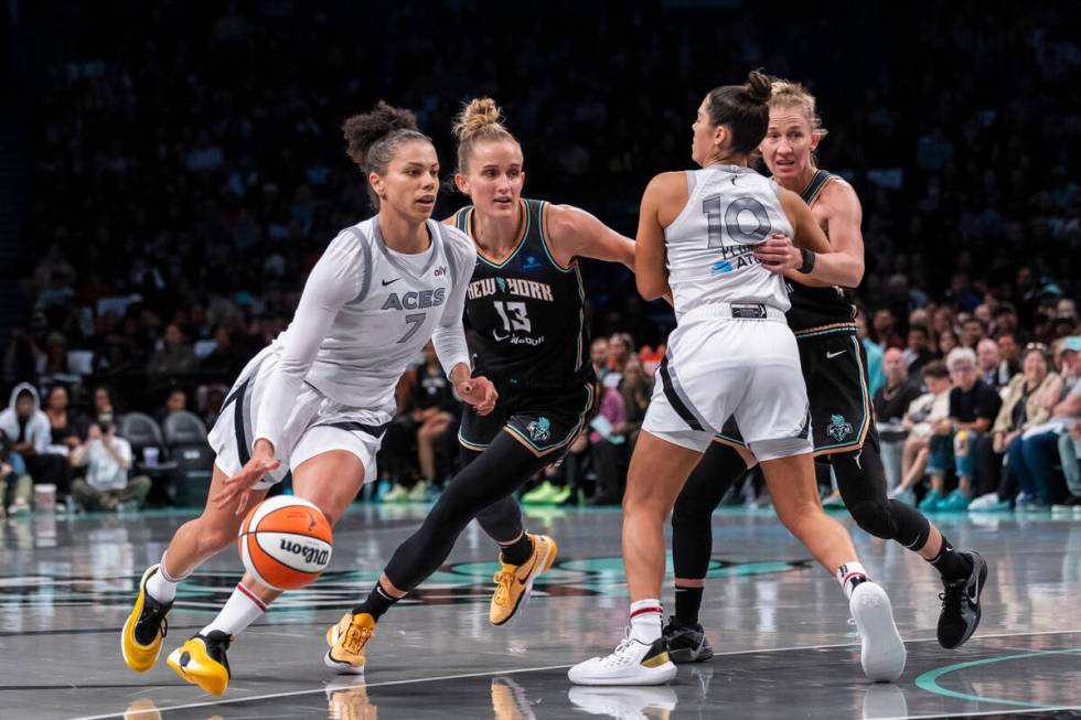 Las Vegas Aces forward Alysha Clark (7) drives past New York Liberty forward Leonie Fiebich (13 ...