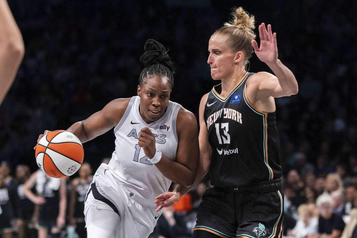 Las Vegas Aces guard Chelsea Gray (12) is defended by New York Liberty forward Leonie Fiebich ( ...