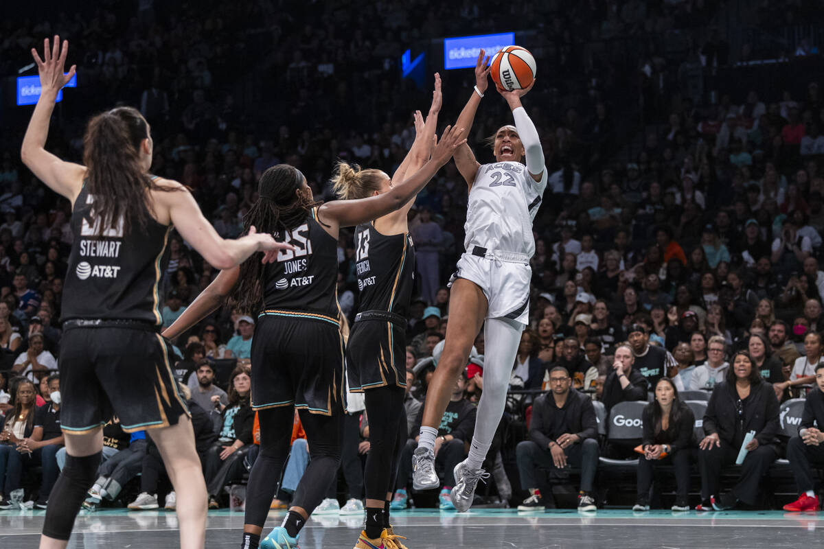 Las Vegas Aces center A'ja Wilson (22) shoots over New York Liberty forward Leonie Fiebich (13) ...