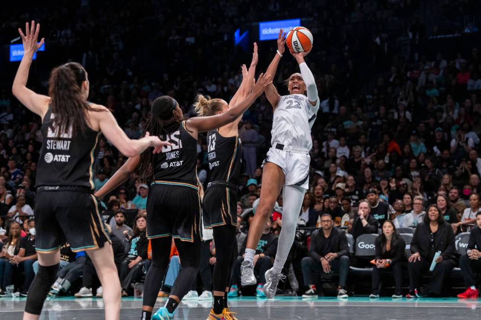 Las Vegas Aces center A'ja Wilson (22) shoots over New York Liberty forward Leonie Fiebich (13) ...