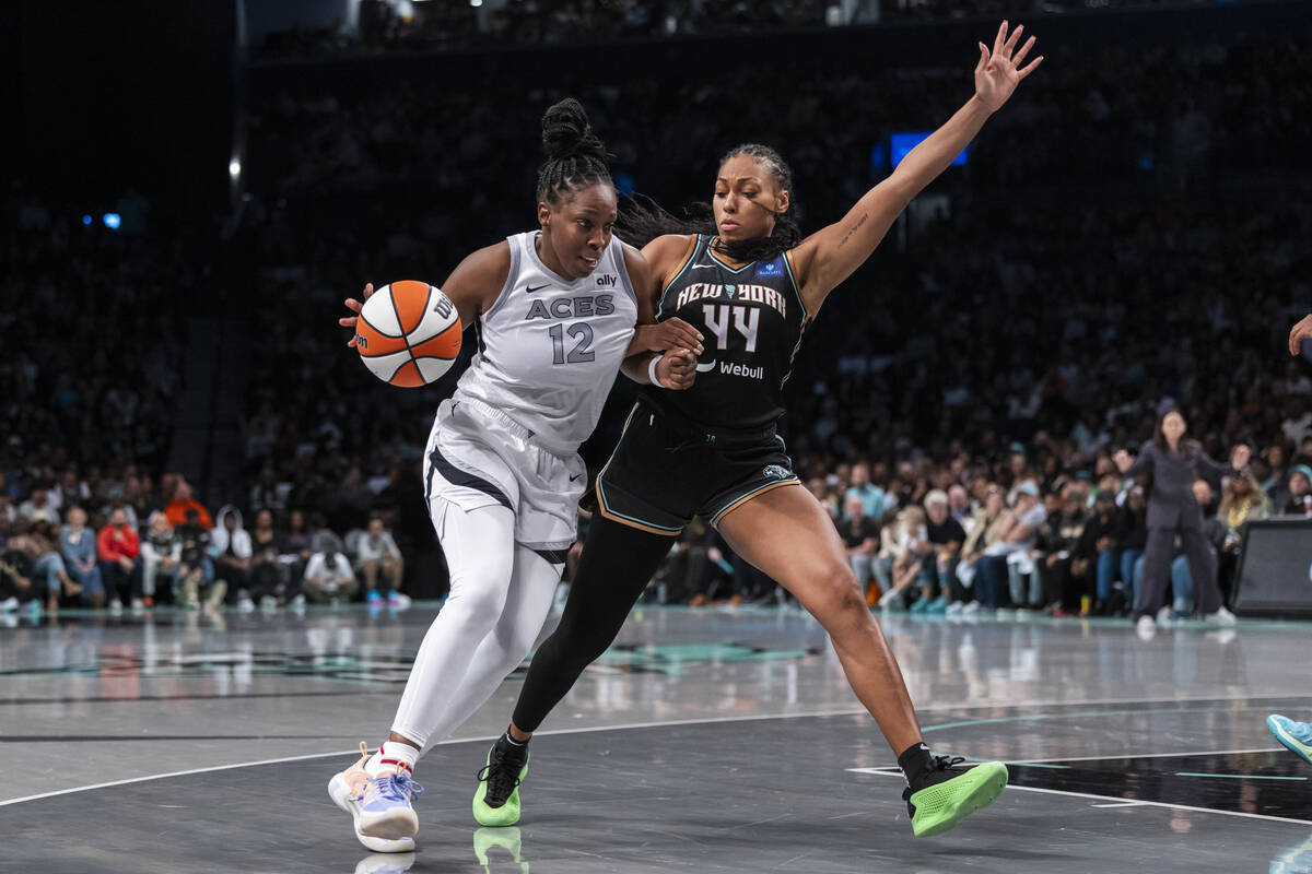 Las Vegas Aces guard Chelsea Gray (12) is defended by New York Liberty forward Betnijah Laney-H ...