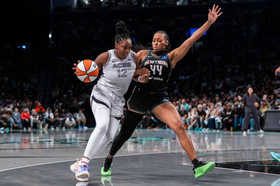 Las Vegas Aces guard Chelsea Gray (12) is defended by New York Liberty forward Betnijah Laney-H ...