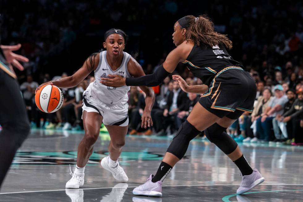 Las Vegas Aces guard Jackie Young, left, is defended by New York Liberty forward Kennedy Burke, ...