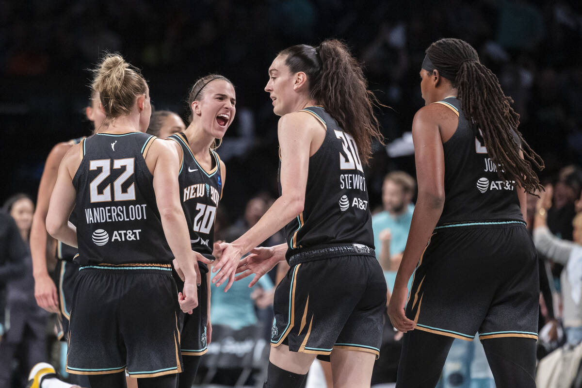 New York Liberty guard Sabrina Ionescu (20) celebrates with forward Breanna Stewart (30) during ...