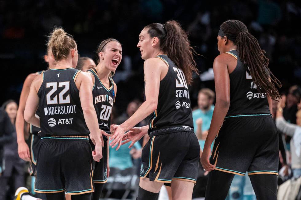 New York Liberty guard Sabrina Ionescu (20) celebrates with forward Breanna Stewart (30) during ...