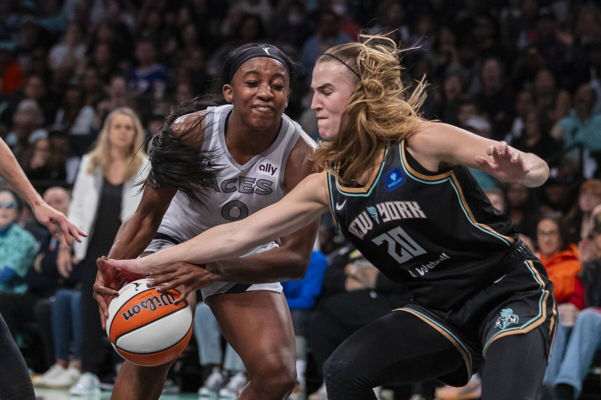 Las Vegas Aces guard Jackie Young (0) is defended by New York Liberty guard Sabrina Ionescu (20 ...