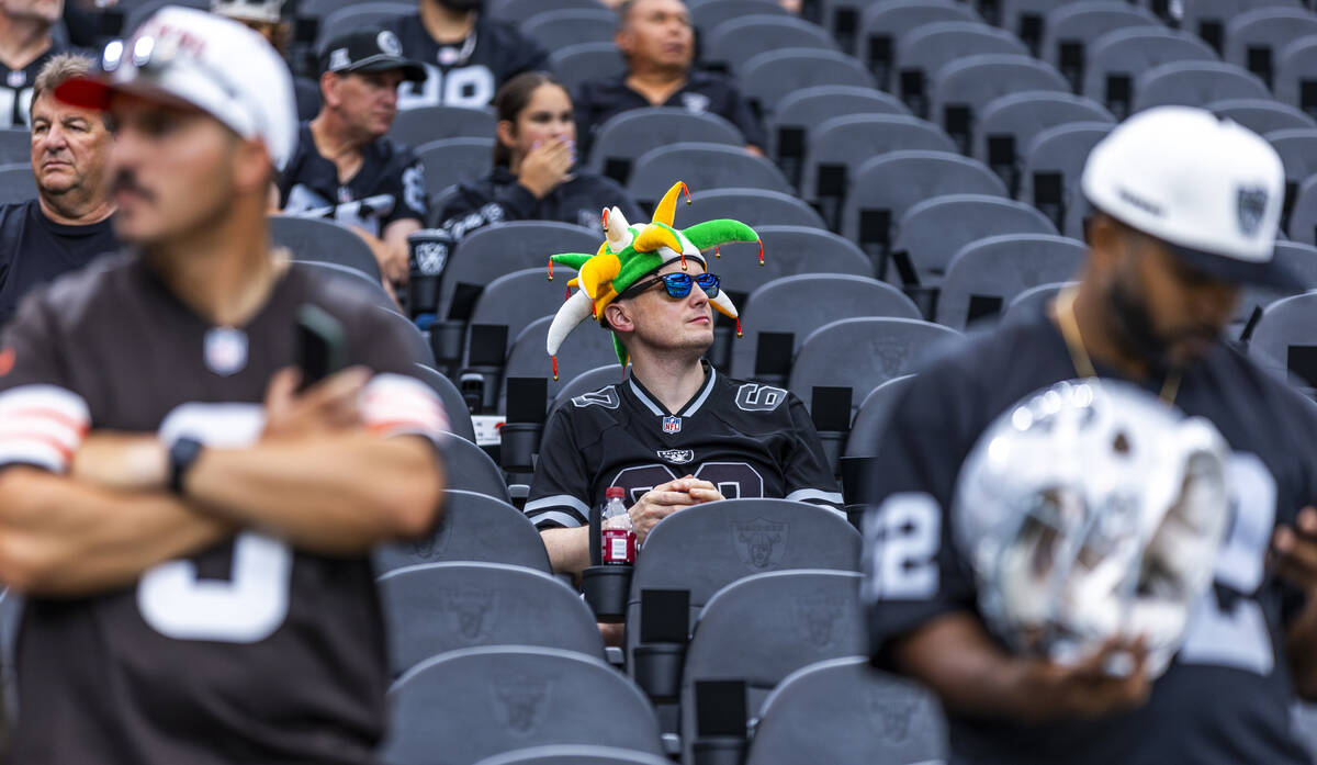 A Raiders fan sits in the stands during the warm ups of their NFL game against the Cleveland Br ...