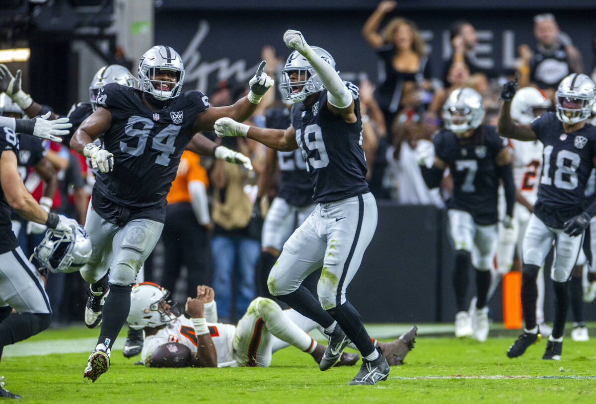 Raiders defensive end Charles Snowden (49) and defensive tackle Christian Wilkins (94) celebrat ...