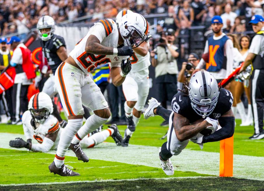 Raiders wide receiver DJ Turner (19) takes a hit from Cleveland Browns cornerback Cameron Mitch ...