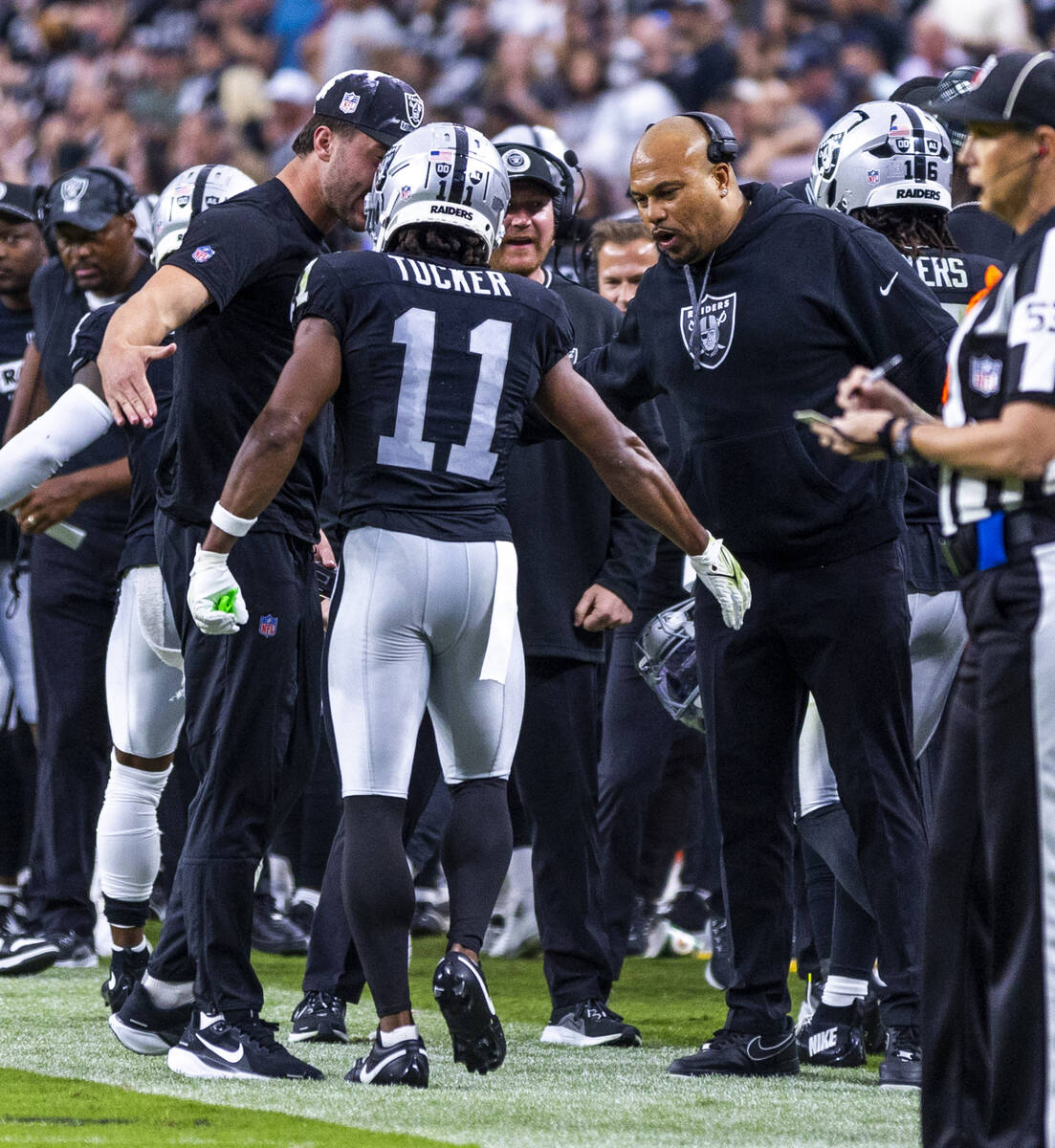 Raiders wide receiver Tre Tucker (11) is congratulated on a score by Head Coach Antonio Pierce ...