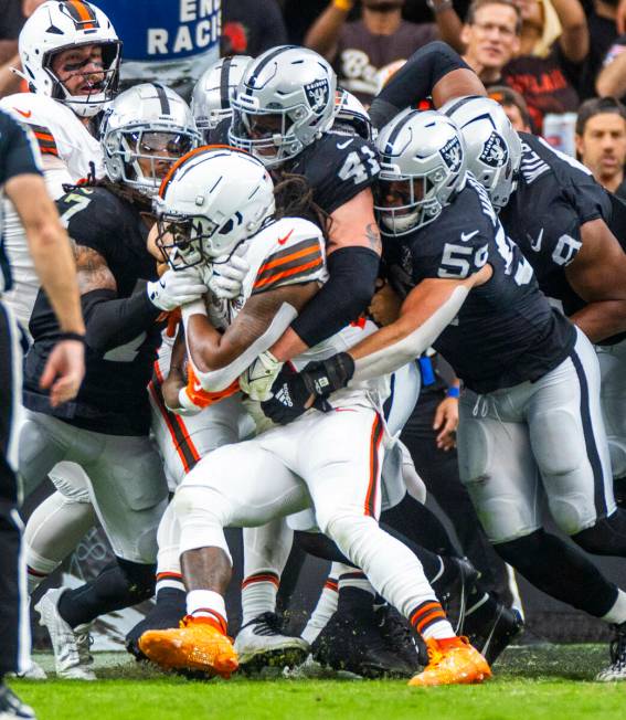 Cleveland Browns running back D'Onta Foreman (27) is gang tackled by a host of Raiders defender ...