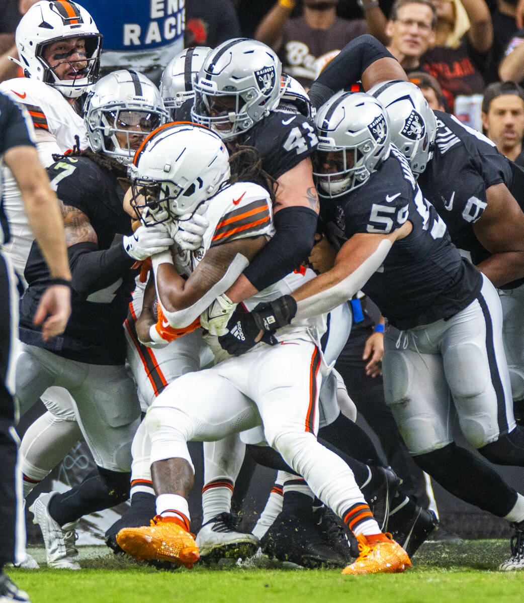 Cleveland Browns running back D'Onta Foreman (27) is gang tackled by a host of Raiders defender ...