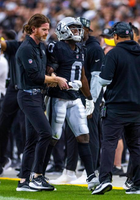 Raiders cornerback Jakorian Bennett (0) is assisted off the field with a possible arm injury ag ...